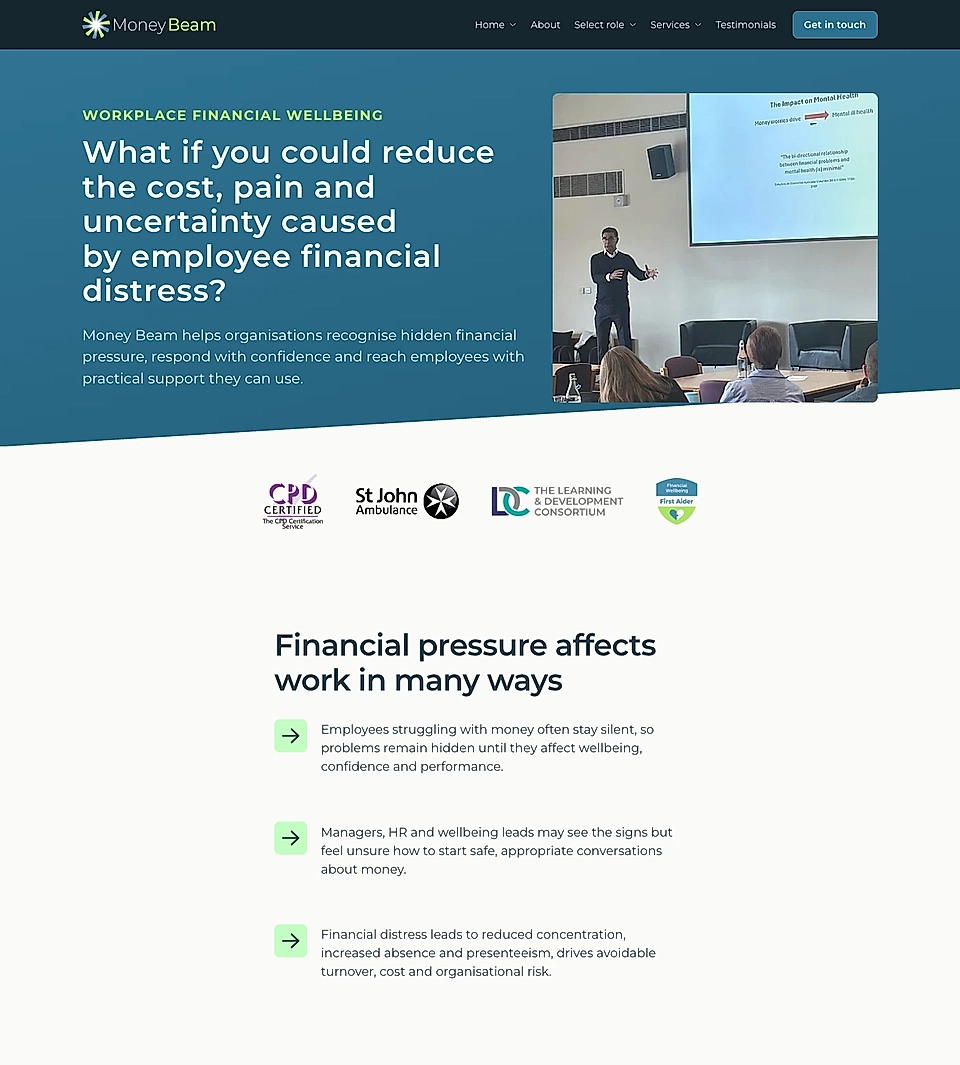 MoneyBeam website homepage with workplace financial wellbeing message and a presentation photo