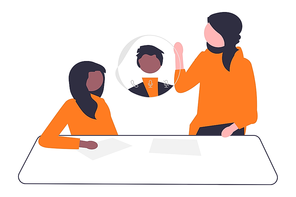 Two business people in a virtual meeting with a video call icon between them at a conference table