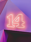 Neon sign displaying the number '14' on a purple geometric background.