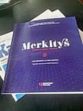 A purple book titled 'Merkitys' by Pasi Saarinen and Timo Suokko, published by Marketing Finland, on a table.