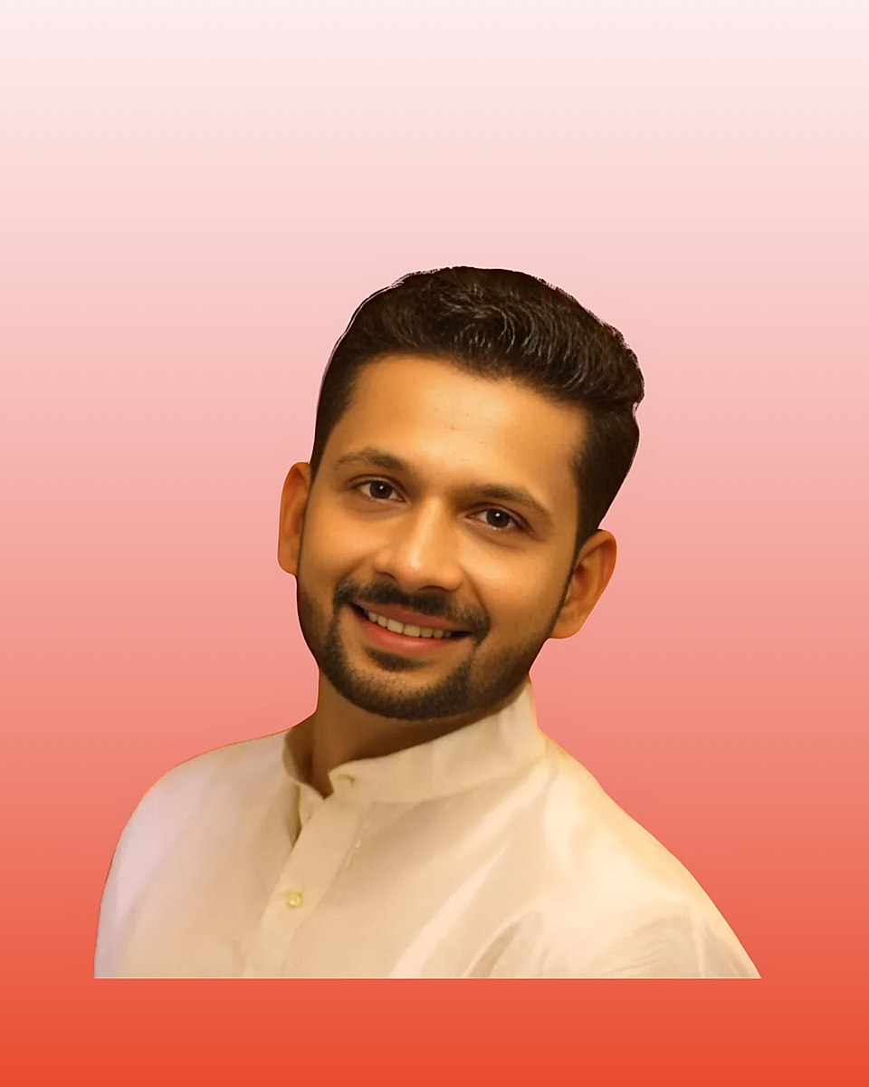 Smiling man in a white shirt against a pink gradient background