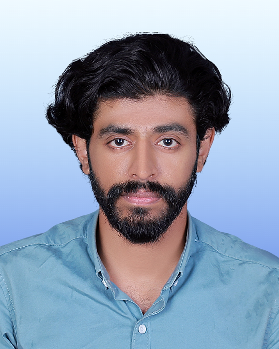 Portrait photo of a man with dark hair and beard against a blue gradient background