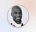 Grayscale profile photo of a smiling man inside an orange circle on a light background