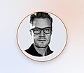 Profile portrait of a man in glasses inside an orange circular frame